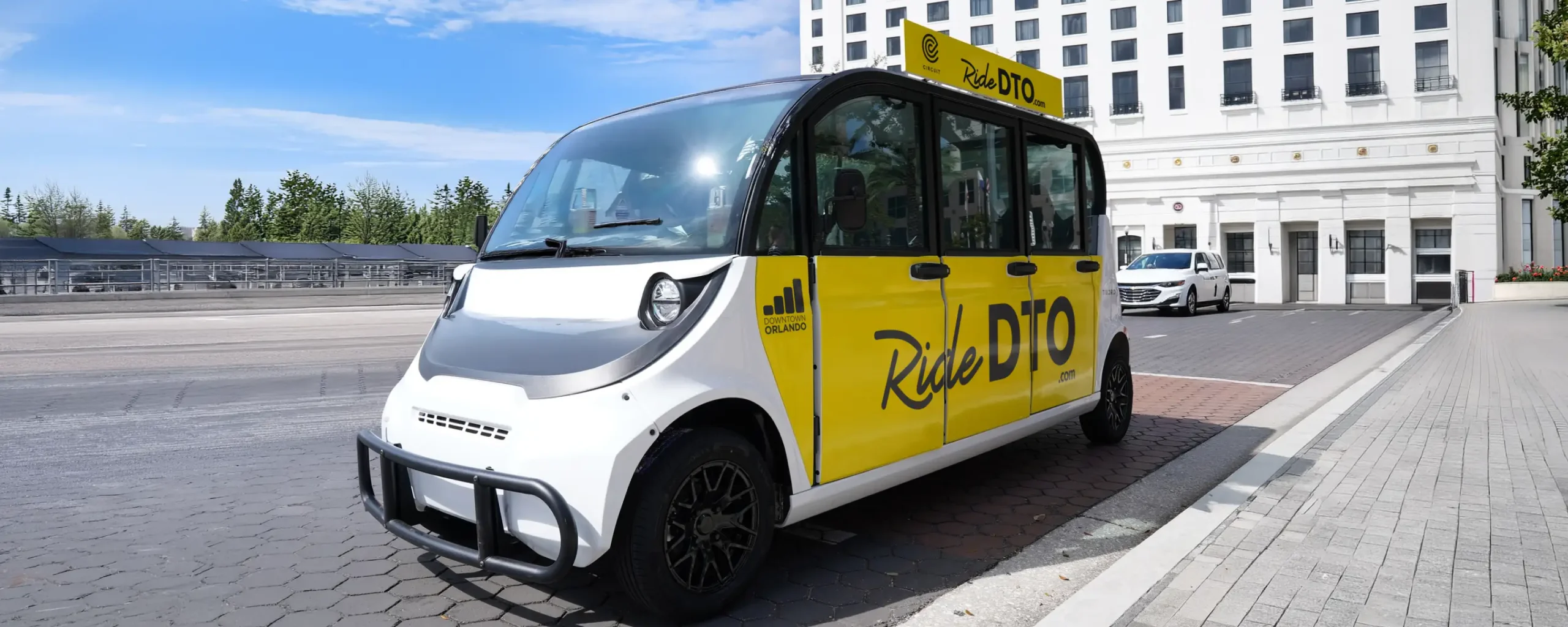 RideDTO vehicle waiting at city curb.