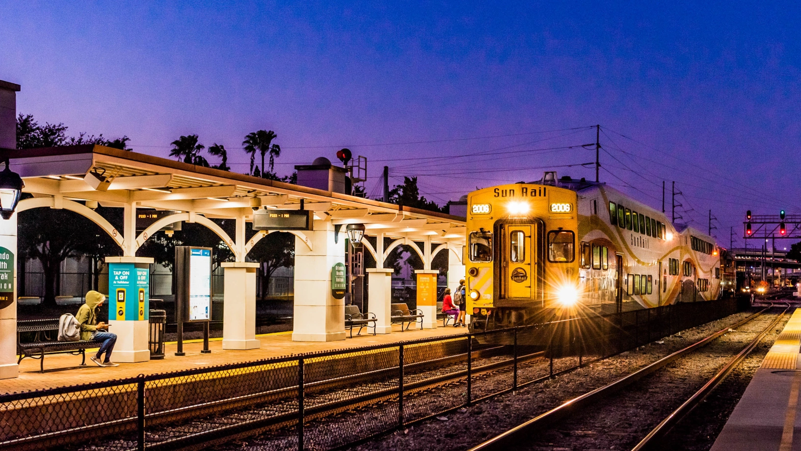 Train departing the Orlando Health / Amtrak SunRail station in the evening.