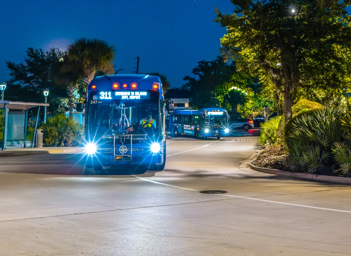 LYNX buses enter the parking lot at a SunRail station.