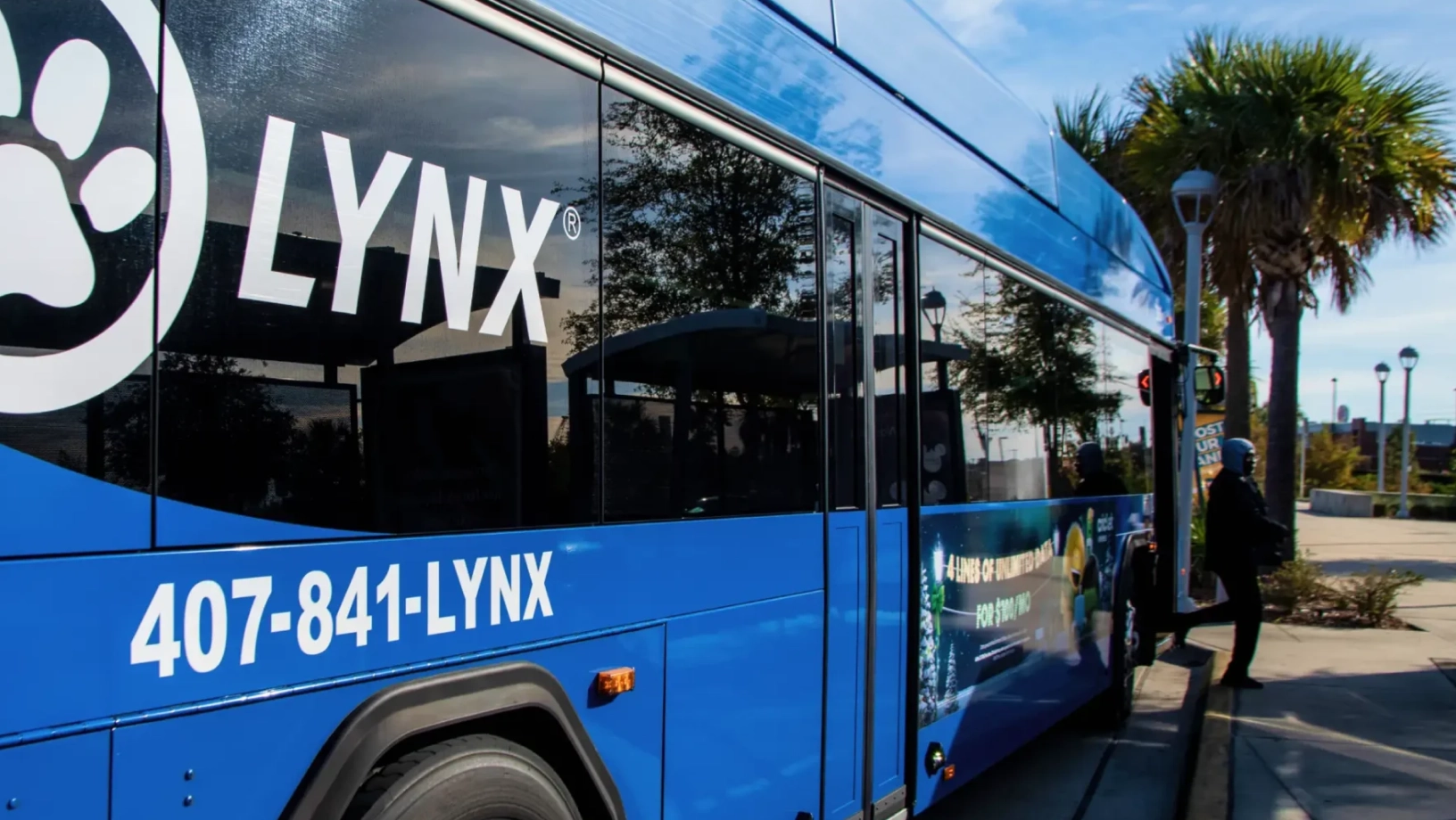 Rider getting off the LYNX bus at a SunRail station.