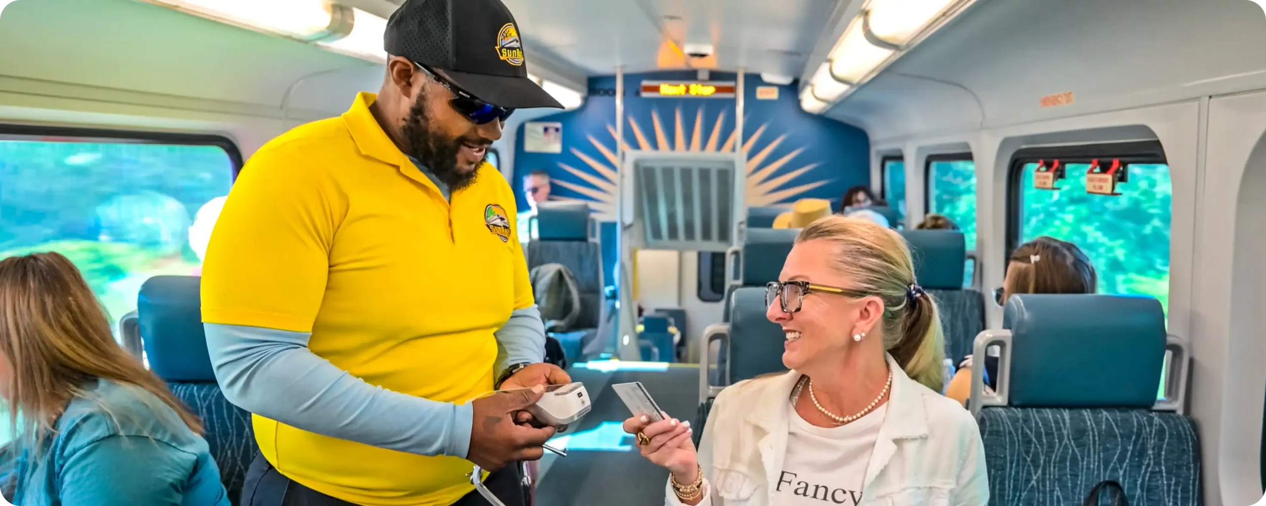 SunRail conductor/fare inspector validating a passenger's ticket.