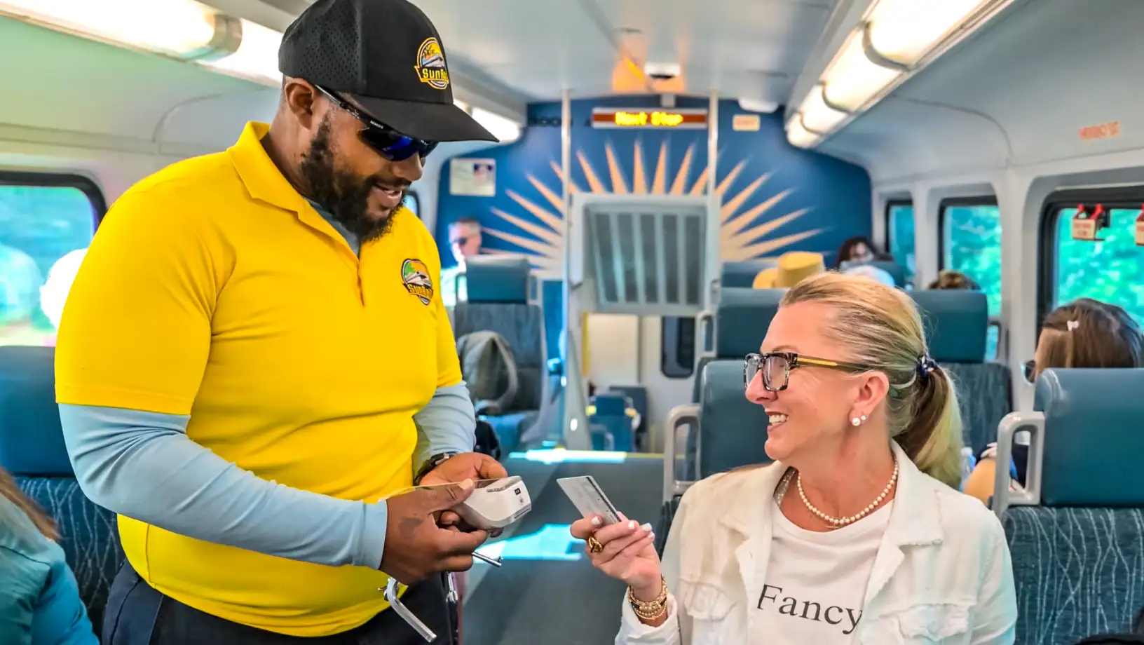 SunRail conductor/fare inspector validating a passenger's ticket.