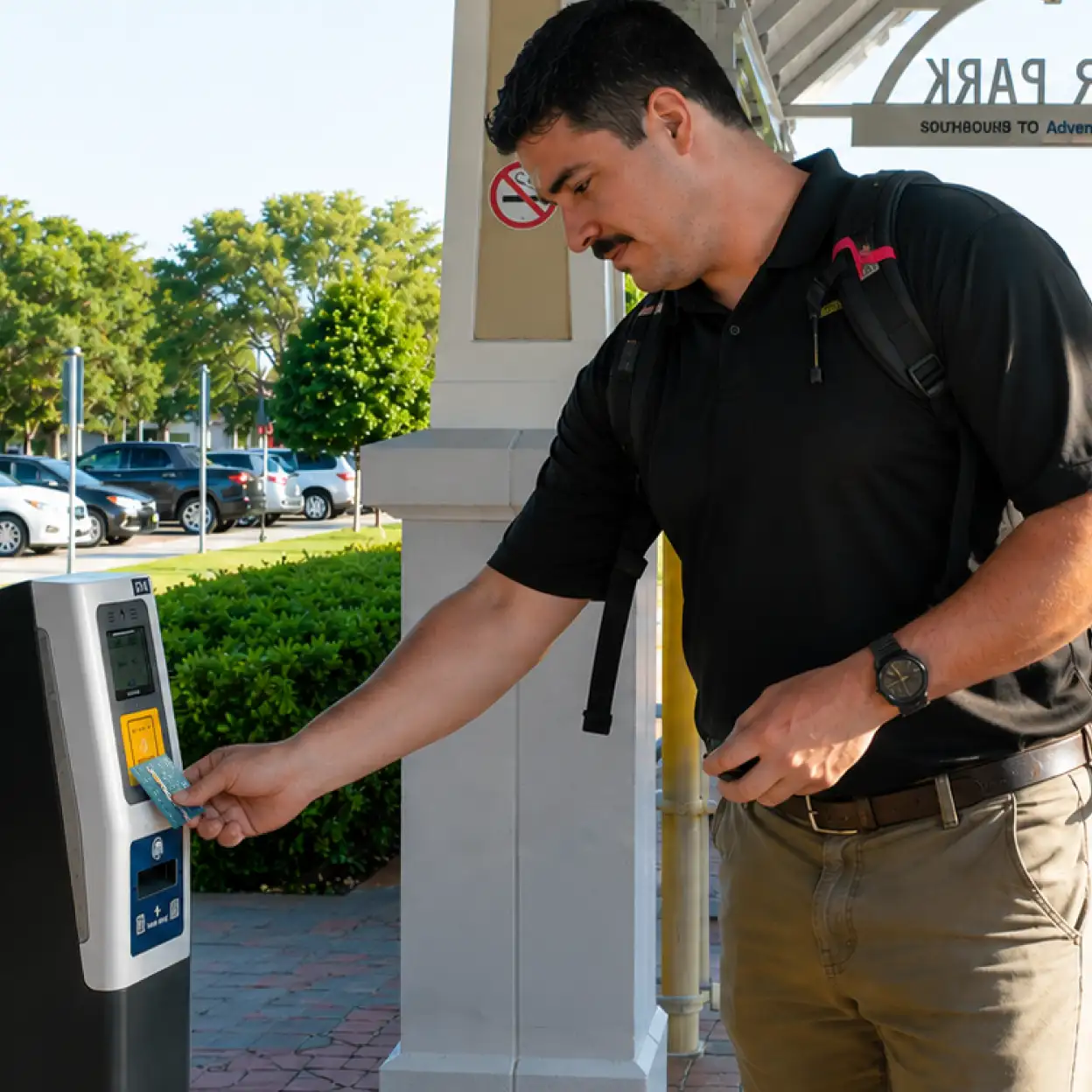 Man using a SunCard at a validator unit.